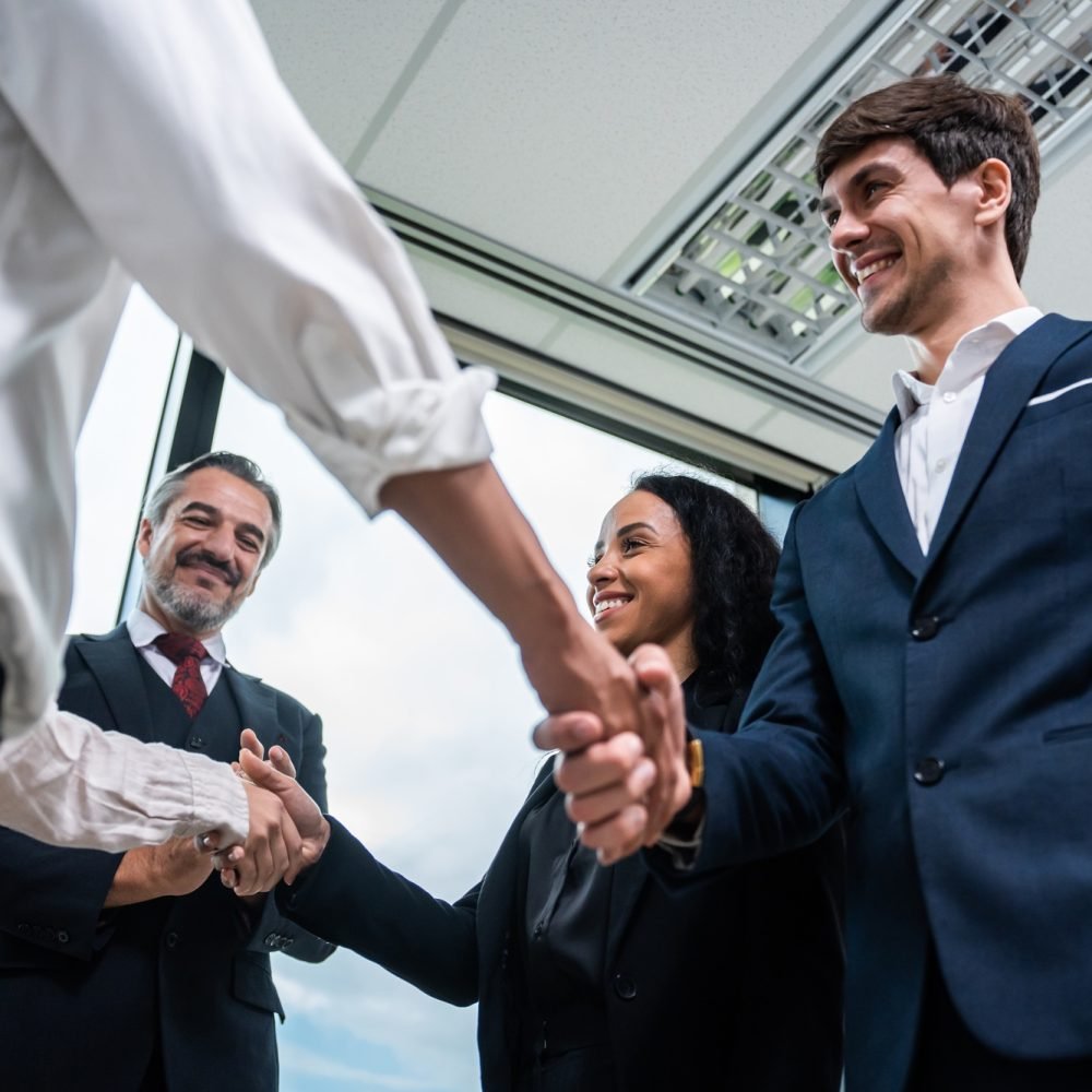 Caucasian businessman making a handshake together while stand in office.